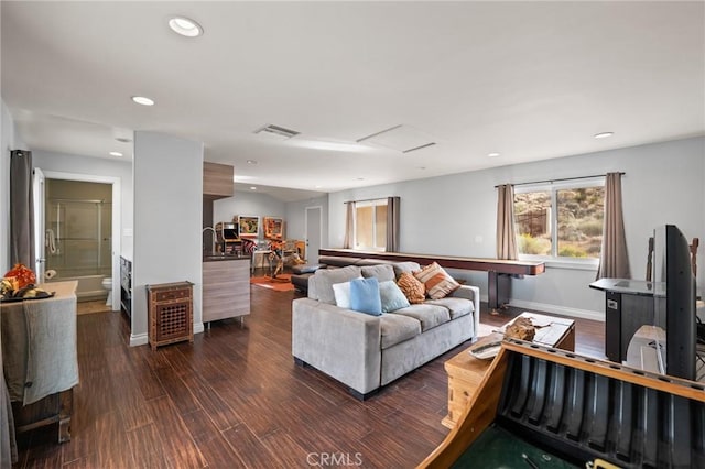 living room featuring attic access, visible vents, baseboards, dark wood-style flooring, and recessed lighting