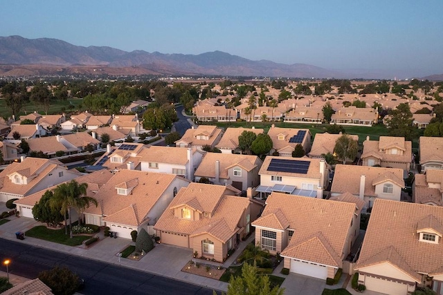 drone / aerial view featuring a residential view and a mountain view