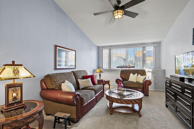 living room with light carpet, ceiling fan, and lofted ceiling