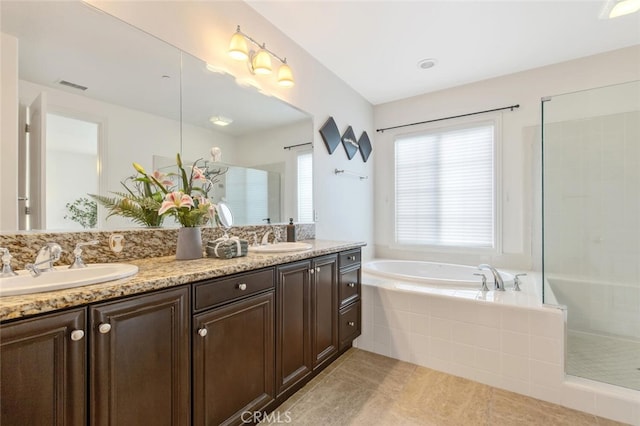 full bathroom with a stall shower, visible vents, a sink, and a garden tub