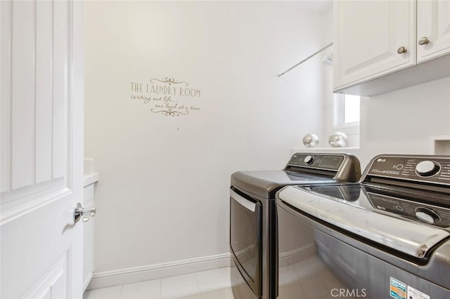 laundry room featuring washing machine and clothes dryer, cabinet space, and baseboards