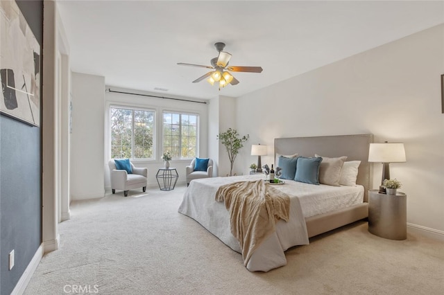 bedroom featuring baseboards, a ceiling fan, and light colored carpet