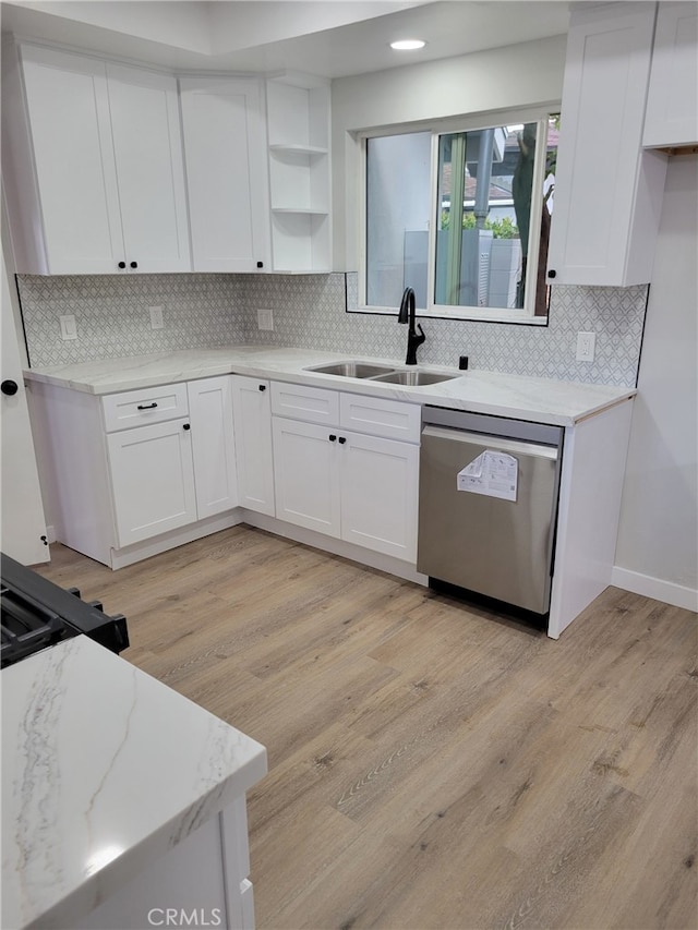 kitchen with a sink, dishwasher, light wood-style flooring, white cabinets, and open shelves