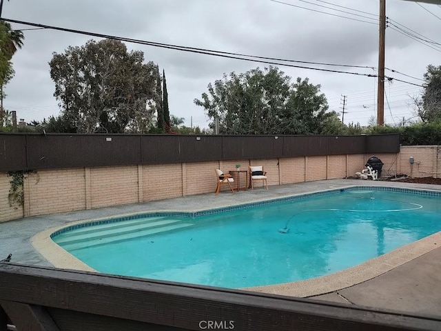 view of pool featuring a fenced backyard and a fenced in pool