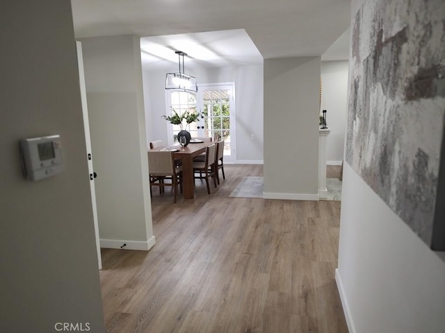 dining room with light wood finished floors and baseboards