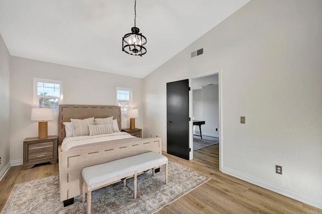 bedroom featuring light wood-style flooring, visible vents, a chandelier, and baseboards