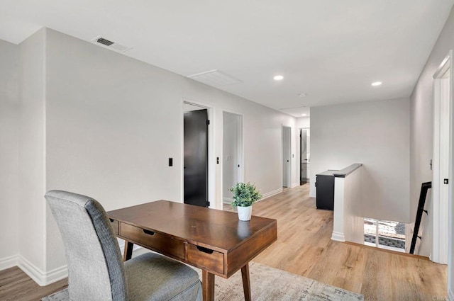 office area with light wood finished floors, baseboards, visible vents, and recessed lighting