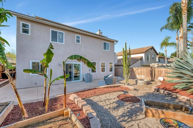 back of property with an outdoor fire pit, fence, stucco siding, a chimney, and a patio area