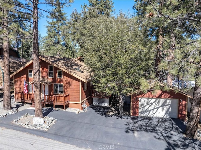 view of front of property with a garage and a deck