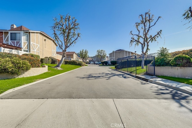 view of street featuring curbs, sidewalks, and a residential view