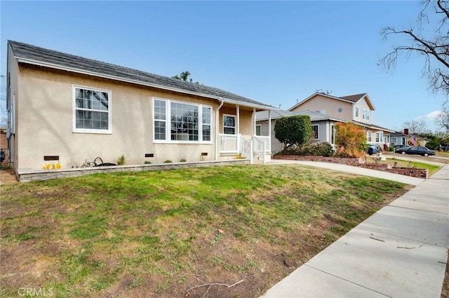 view of front facade with crawl space, a front lawn, and stucco siding