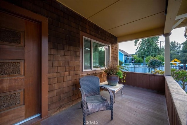 view of patio / terrace with a porch and fence