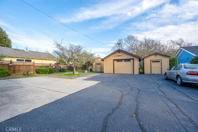 exterior space with a storage unit and fence