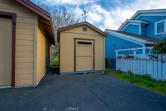 view of shed with fence