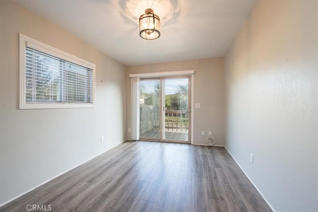 spare room featuring wood finished floors