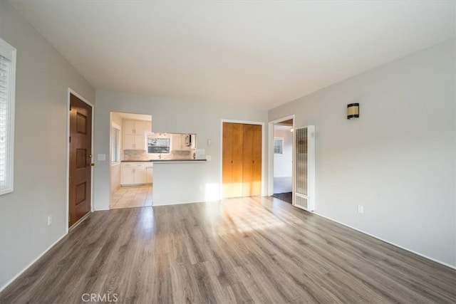 unfurnished living room featuring wood finished floors