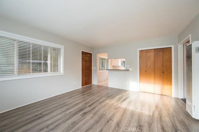 unfurnished living room with wood finished floors