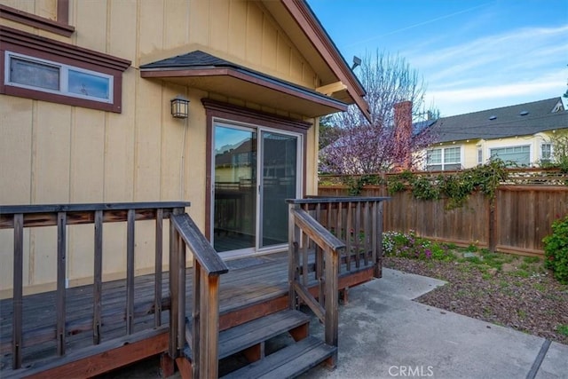 wooden deck with a patio area and fence