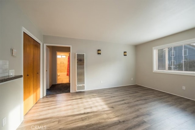 empty room featuring visible vents and light wood-style floors