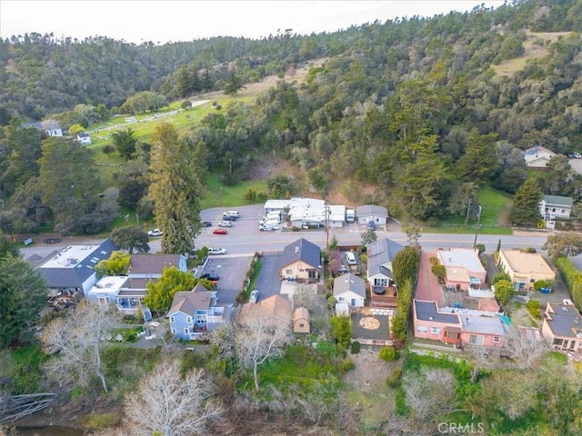 bird's eye view featuring a forest view and a residential view