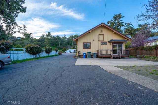 exterior space with a wooden deck and fence