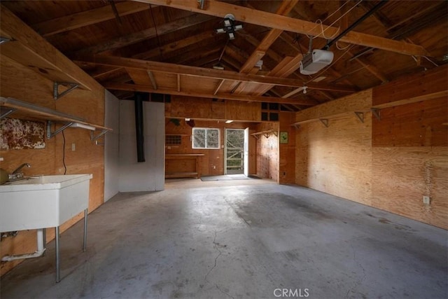 garage featuring a garage door opener and a sink