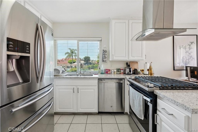 kitchen with white cabinets, island range hood, stainless steel appliances, and a sink