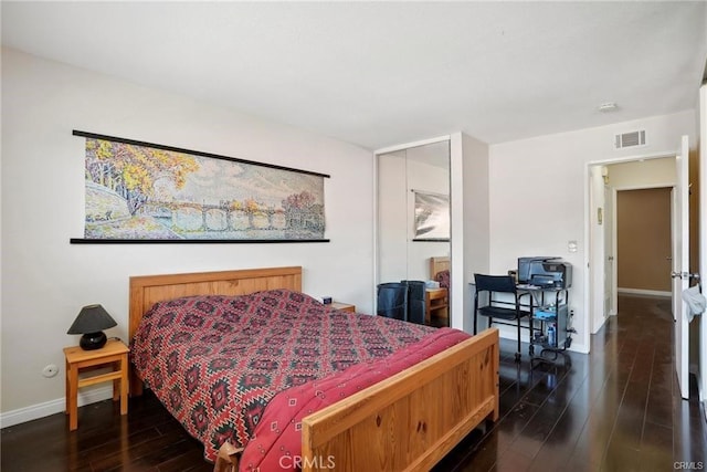 bedroom featuring dark wood-style flooring, visible vents, and baseboards