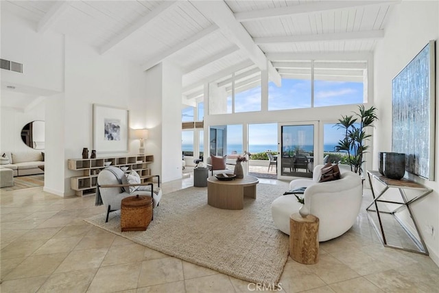 sunroom / solarium featuring a water view, lofted ceiling with beams, and visible vents