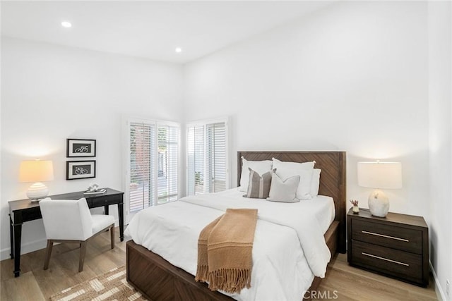 bedroom with recessed lighting, light wood-style flooring, and baseboards