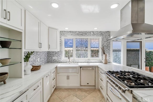 kitchen with light stone counters, stovetop, island exhaust hood, and white cabinetry