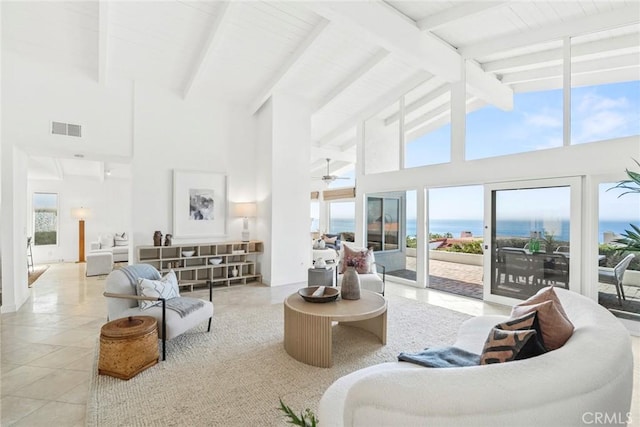 living area featuring visible vents, beamed ceiling, a water view, high vaulted ceiling, and light tile patterned flooring