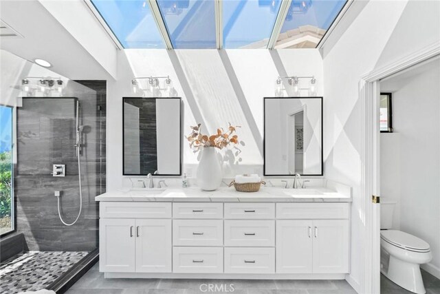 bathroom with a walk in shower, a sink, toilet, and double vanity