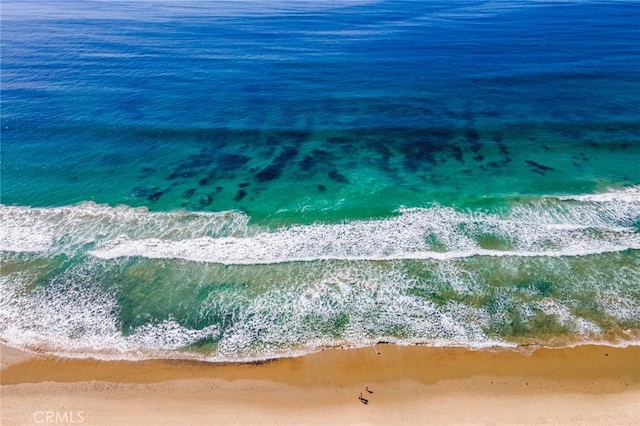 aerial view with a water view and a beach view