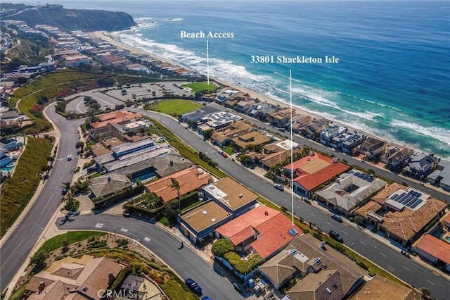 bird's eye view with a water view, a residential view, and a beach view