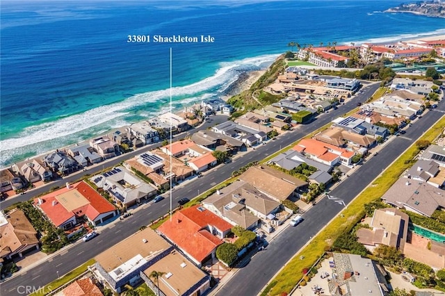 aerial view with a beach view, a water view, and a residential view