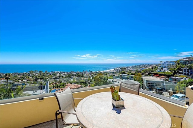 balcony featuring a water view and a city view