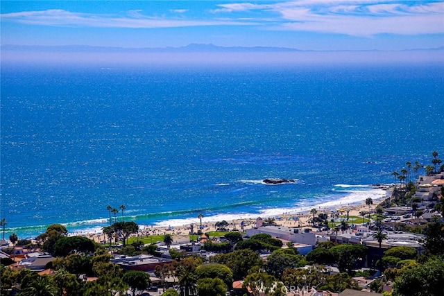 birds eye view of property with a water view and a view of the beach