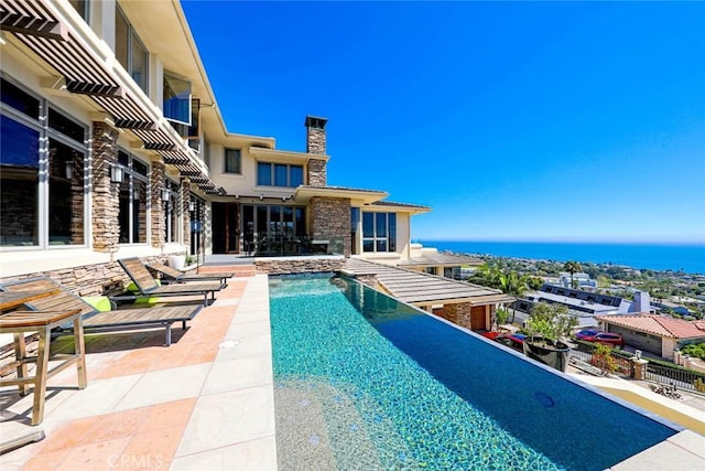 view of pool with a water view and an infinity pool