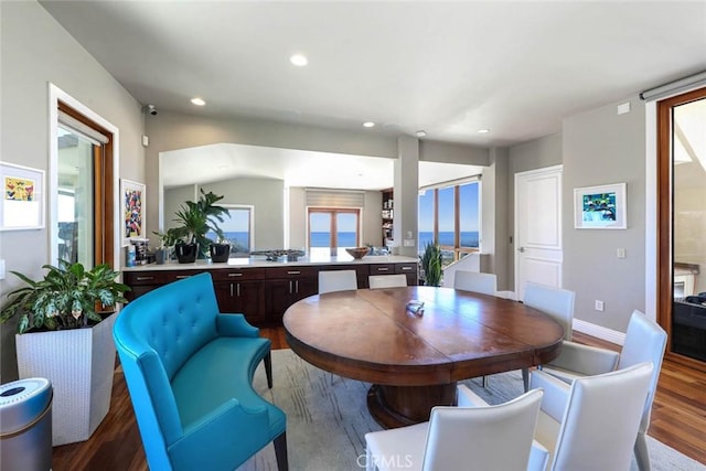 dining space with recessed lighting, vaulted ceiling, dark wood finished floors, and baseboards