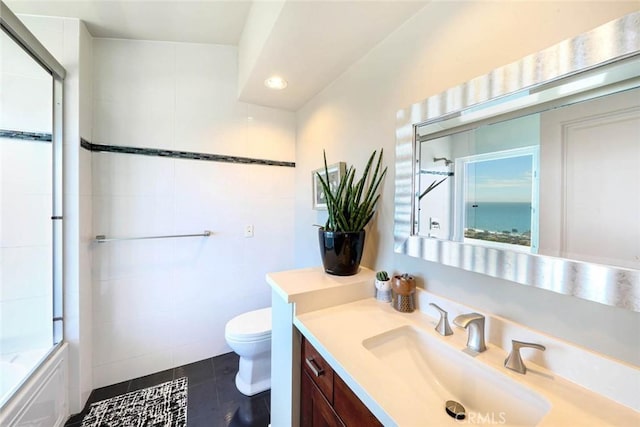 bathroom featuring recessed lighting, toilet, enclosed tub / shower combo, vanity, and tile patterned floors