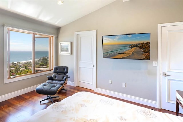 living area featuring a water view, vaulted ceiling, baseboards, and wood finished floors