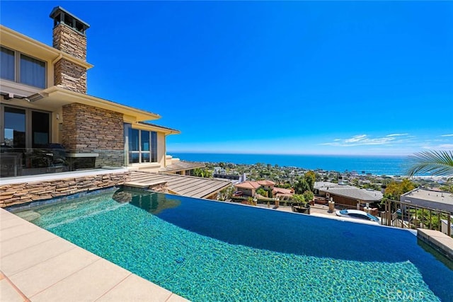 view of swimming pool featuring a water view