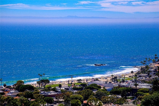 bird's eye view featuring a water view and a beach view