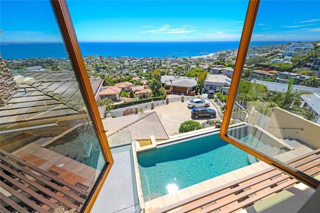 view of swimming pool with a water view