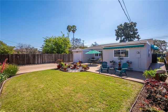 view of yard with a patio area and a fenced backyard