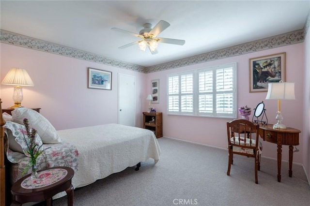 carpeted bedroom featuring a ceiling fan and baseboards