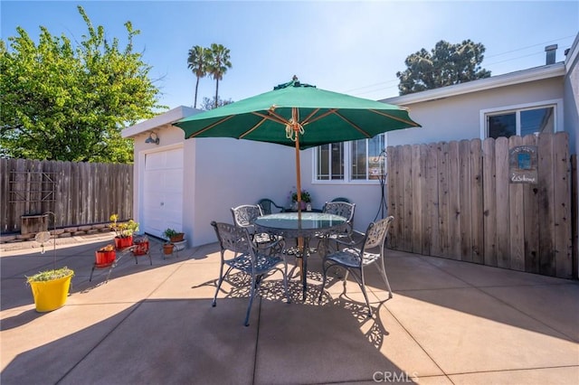 view of patio / terrace featuring outdoor dining area and fence