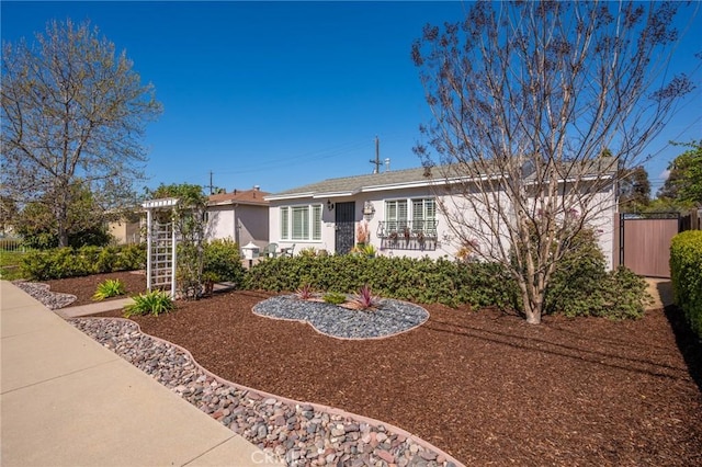 single story home with fence and stucco siding