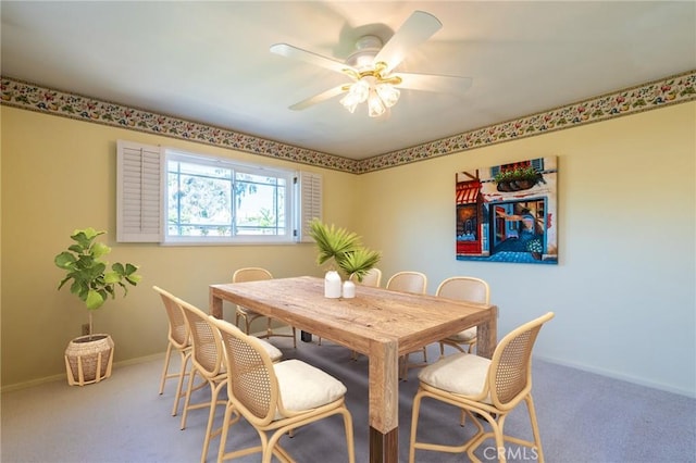 dining space featuring carpet flooring, baseboards, and ceiling fan